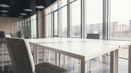 Tableau sur toile Empty modern conference table and comfortable chairs in a bright, spacious office meeting room bathed in natural light
