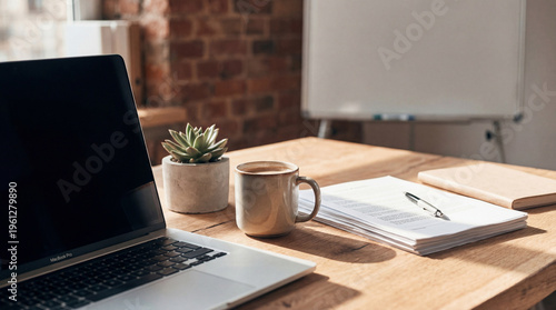 Foto Wooden office desk close-up with laptop, coffee, succulent plant, documents, and whiteboard