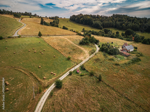 Aerial view of Big Bench 169 in Sudetes mountains, Poland. Scenic countryside landscape with hay bales and rural farm.