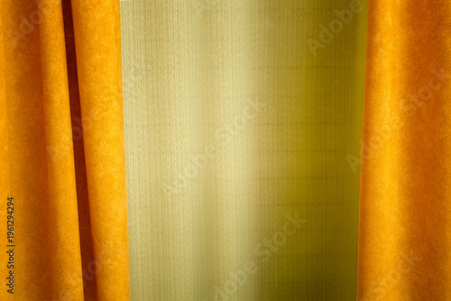 Orange curtain background with green center contrast and textured surface