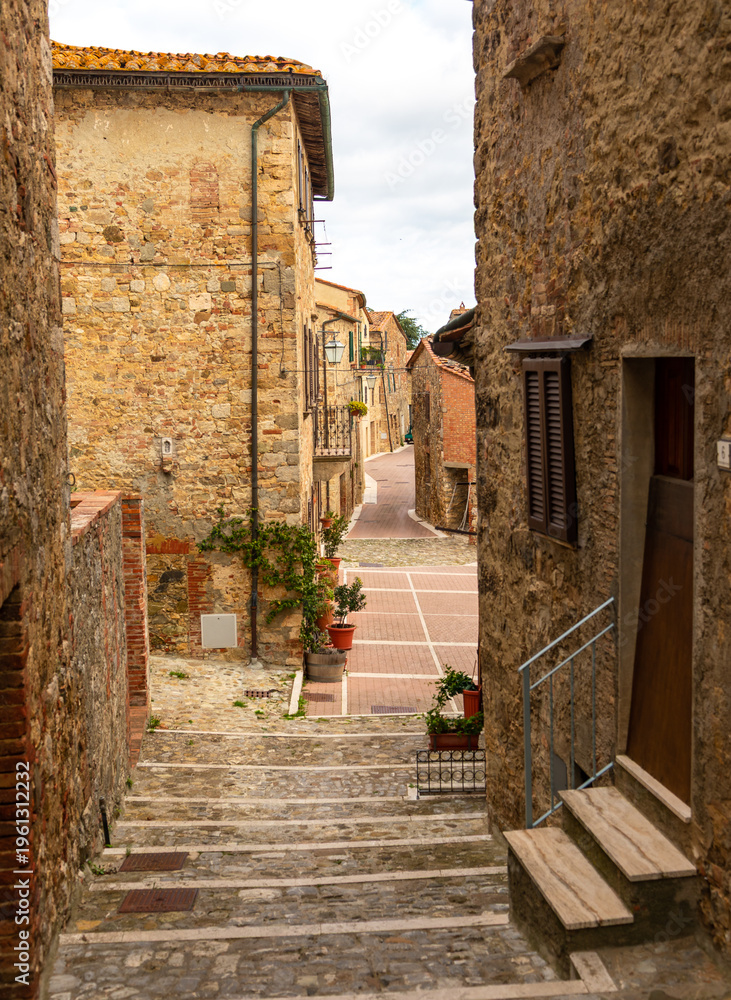 Fototapeta premium Stone steps descending into narrow Castiglione d'Orcia street, Tuscany, Italy.
