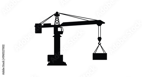 Industrial tower crane lifting a load a stark black silhouette