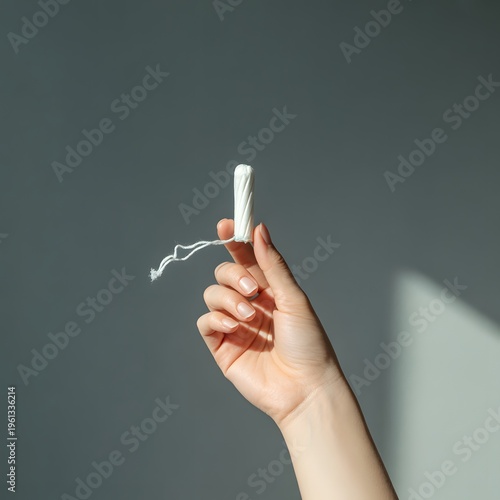 Obraz na płótnie A hand holding a tampon applicator with a string attached