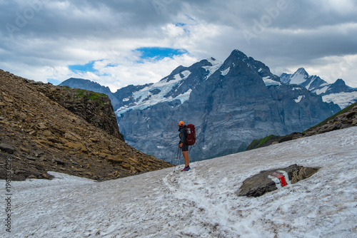 Sporty woman hiking in Switzerland alps. Heathy lifestyle, sport, beauty in nature. Grindelwald valley, Swizz