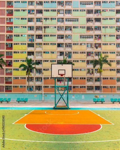View of the vibrant basketball court and the iconic pastel-colored residential facade of Choi Hung Estate Hong Kong.