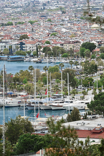Yachts in Fethiye Marina with Palm Trees and City Background – Mediterranean Coastal Life in Turkey