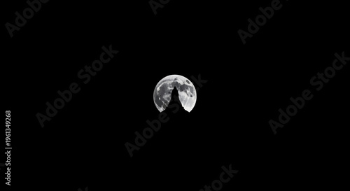 Mysterious Howling Wolf Silhouette Against a Full Moon in a Dark Night Sky, Wild Nature Scene on Solid Black Background