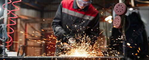 Close up of sparks from angle grinder cutting metal indoors