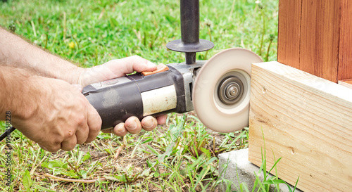 Wallpaper Mural Worker cuts wood with hand-held power tool Torontodigital.ca