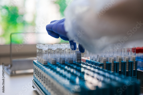 Bild auf Leinwand Expert Technician Systematically Handling Laboratory Vials In Sterilized Environ