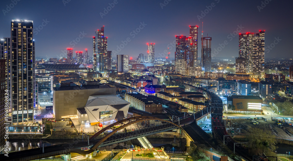 Fototapeta premium Manchester city centre Castlefield aerial view at dusk, River Irwell waterfront skyline, illuminated urban cityscape, canals and bridges, UK travel destination, modern regeneration and architecture