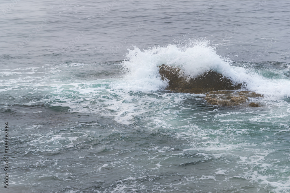 Fototapeta premium Atlantic Ocean Wave Crashes Over Small Rock