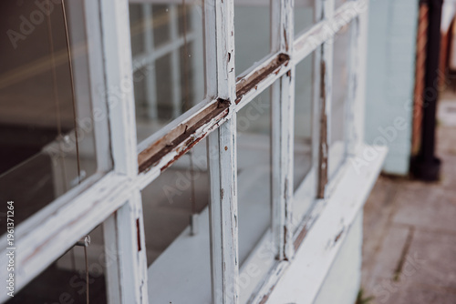 Weathered wooden window frames with peeling paint detail