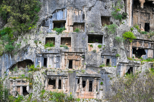 Fethiye Rock Tombs on Cliff with Green Vegetation – Ancient Lycian Telmessos Ruins in Turkey
