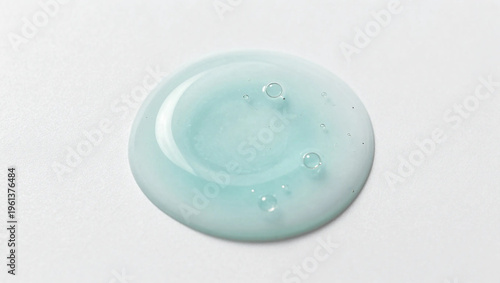 Single Light Teal Cosmetic Gel Drop with Bubbles on White Background