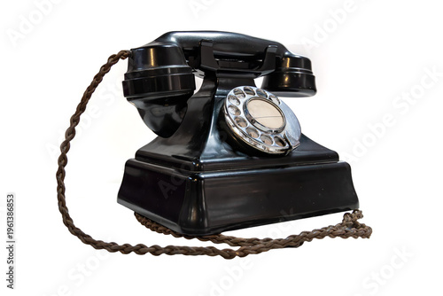 Black bakelite rotary telephone isolated on white background