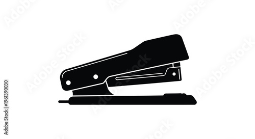 A black silhouette of a classic office stapler simply defined silhouette
