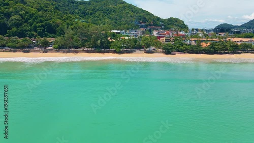 Peaceful Beach With Lush Landscape. Idyllic Coastal Panorama Showcasing Calm Water And Natural Beauty