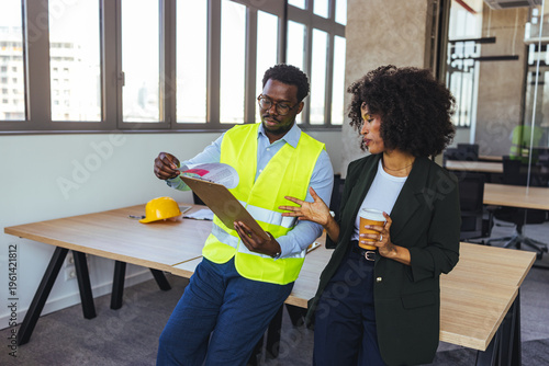 Photos Business Colleagues Discussing Construction Plans in Office With Safety Vest and