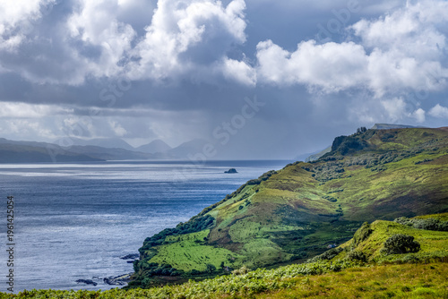 Coastline along Trotternish escarpment on Isle of Skye with hills and water in view