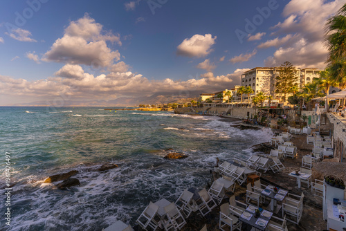 Sunset view of taverna with a coastline and sea in Limenas Chersonisou, Crete, Greek Islands, Greece