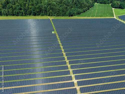 Solar panels covering large area in Upper Swabia region of Baden-Wurttemberg, Germany with green fields nearby