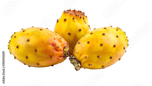Three ripe, yellow cactus fruits with dark spots and a partially removed stem on black