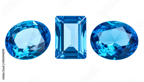 Three translucent, blue gemstones of varying cuts, set against a black backdrop