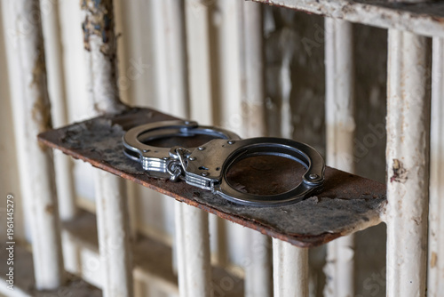 Lansing, Kansas. Closeup of  a pair of hand cuffs resting on cell door in prison.