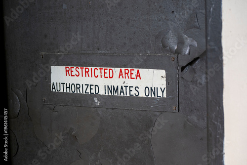 Restricted area sign on prison door.