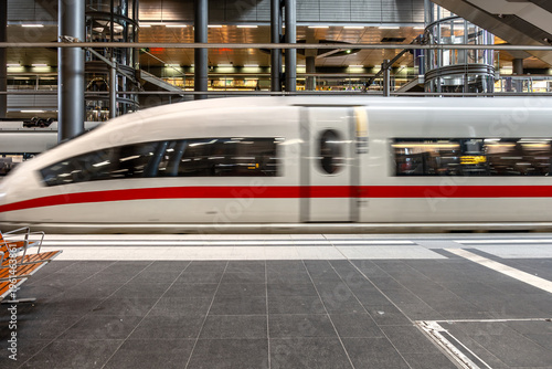 High speed train moving at modern station. Transport infrastructure motion concept.