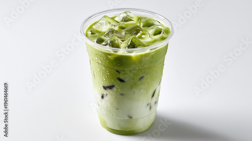 Refreshing iced matcha latte in a clear glass cup, creamy green tea drink with milk, minimal aesthetic, perfect for cafe menu or summer beverage concept.