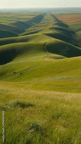 Rolling green hills with winding roads in countryside landscape