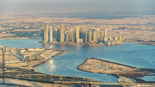 Photography Aerial view of Dubai Creek Harbour skyscrapers at sunset