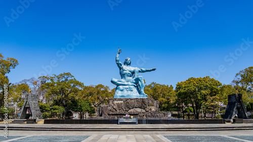 Peace Statue in Nagasaki Peace Park under a clear blue sky