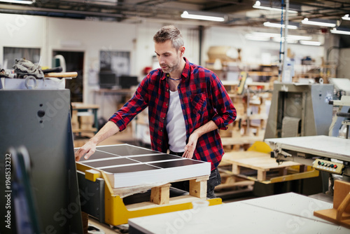 Fotografija Male print worker checking sheets in factory