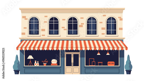 Elegant two-story building featuring a ground floor boutique store with a striped awning and large display windows showcasing home decor.
