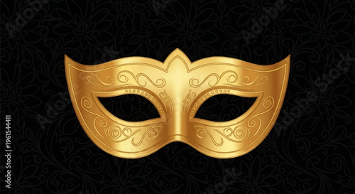 Golden ornate eye mask for masquerade with intricate filigree engraving on a black floral patterned background, suitable for carnival, ball, or theater costume accessory.