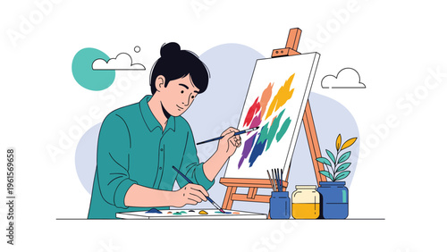 Creative female artist sitting in an art studio and painting a colorful abstract piece on a canvas on an easel.