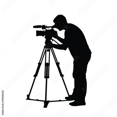 Silhouette of a professional cameraman with video camera on tripod