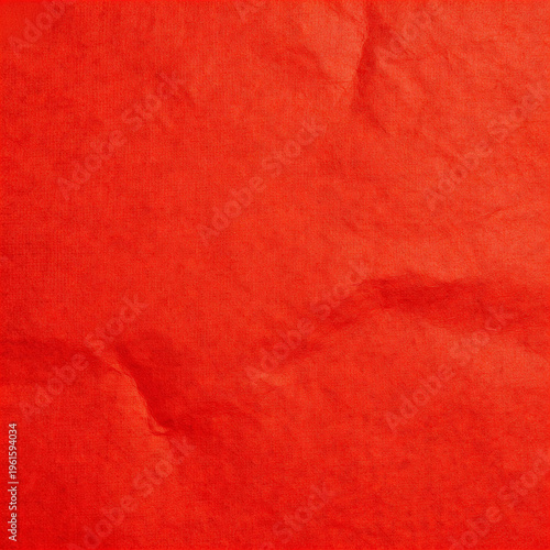 Red textured paper background with rough vintage surface and fabric pattern
