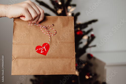 woman holding paper bag with number sticker.christmas advent calendar