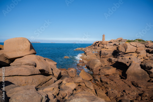 Landscape with Phare Mean Ruz Lighthouse on a sunny day. landmarks in Ploumanach, Brittany, France. travel destination, copy space banner