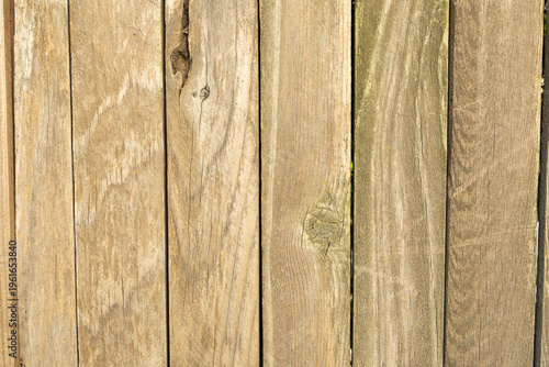 Wooden Fence Boards Stacked Vertically Showing Different Textures and Shades in a Simple Pattern