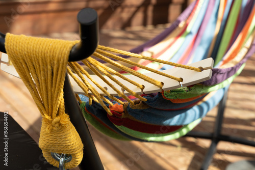 Colorful Hammock Resting on a Support Structure With Bright Ropes in a Sunny Outdoor Space During the Day