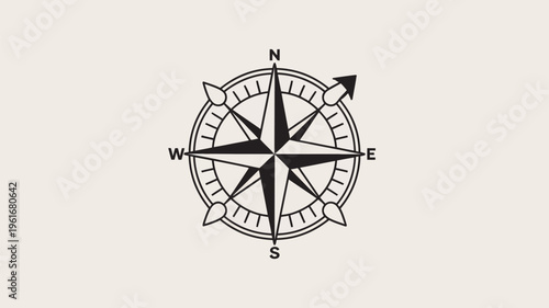 A black compass with a star in the center on a beige background