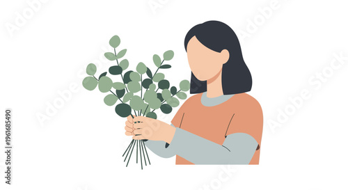 Woman holding a bunch of eucalyptus.
