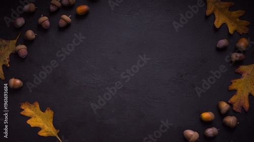 acorns. Autumn arrangement of maple leaves and acorns in a corner pattern on a dark textured surface, warm seasonal still life. representing seasonal cycles and harvest abundance.
