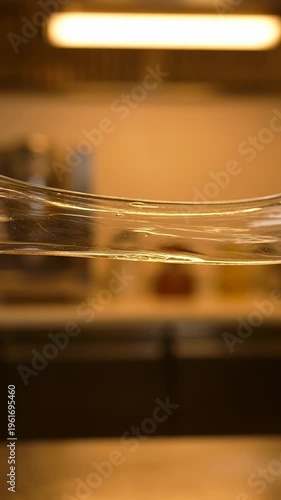 Stretching slime in warm indoor lighting