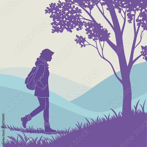 A person walking on a hillside next to a tree